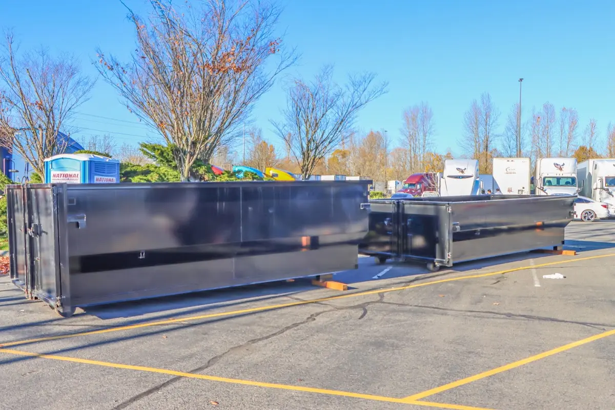 Professional dumpster rental service with roll-off container on residential driveway in Petersburg